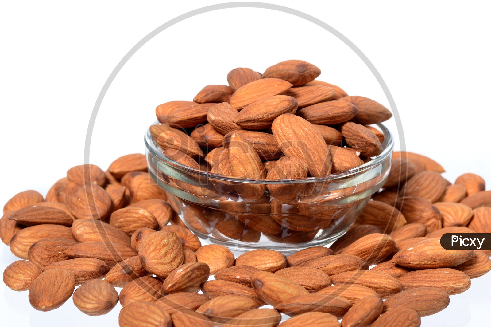 Almonds Or Badam Nuts Heap In a Glass Bowl On an Isolated White Background