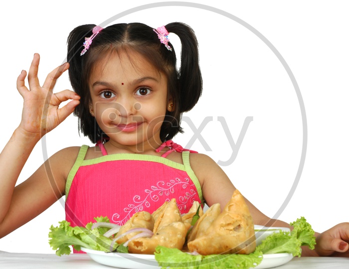 Indian little girl doing a super sign