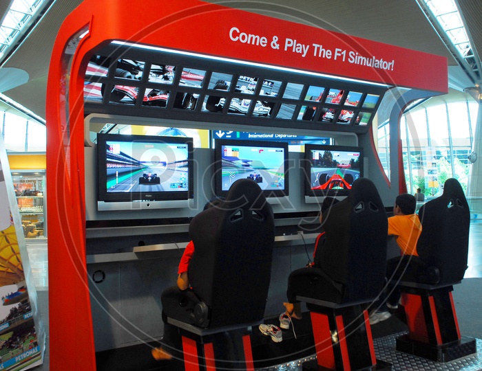 Children playing F1 simulator game
