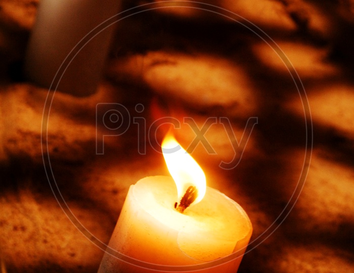 Wax Candle Lighted In a Dark Room