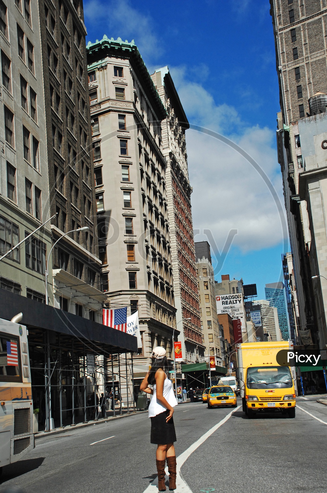 A woman crossing the road in the streets of New York