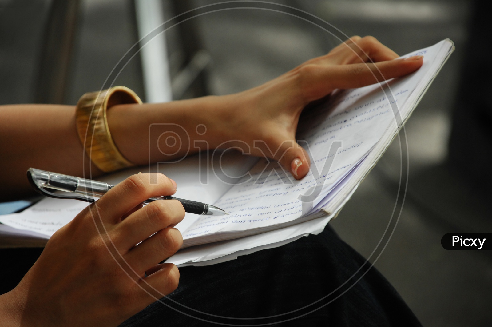 A girl writing with a pen
