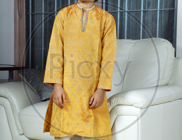 Indian boy wearing yellow kurta pyjama and sunglasses
