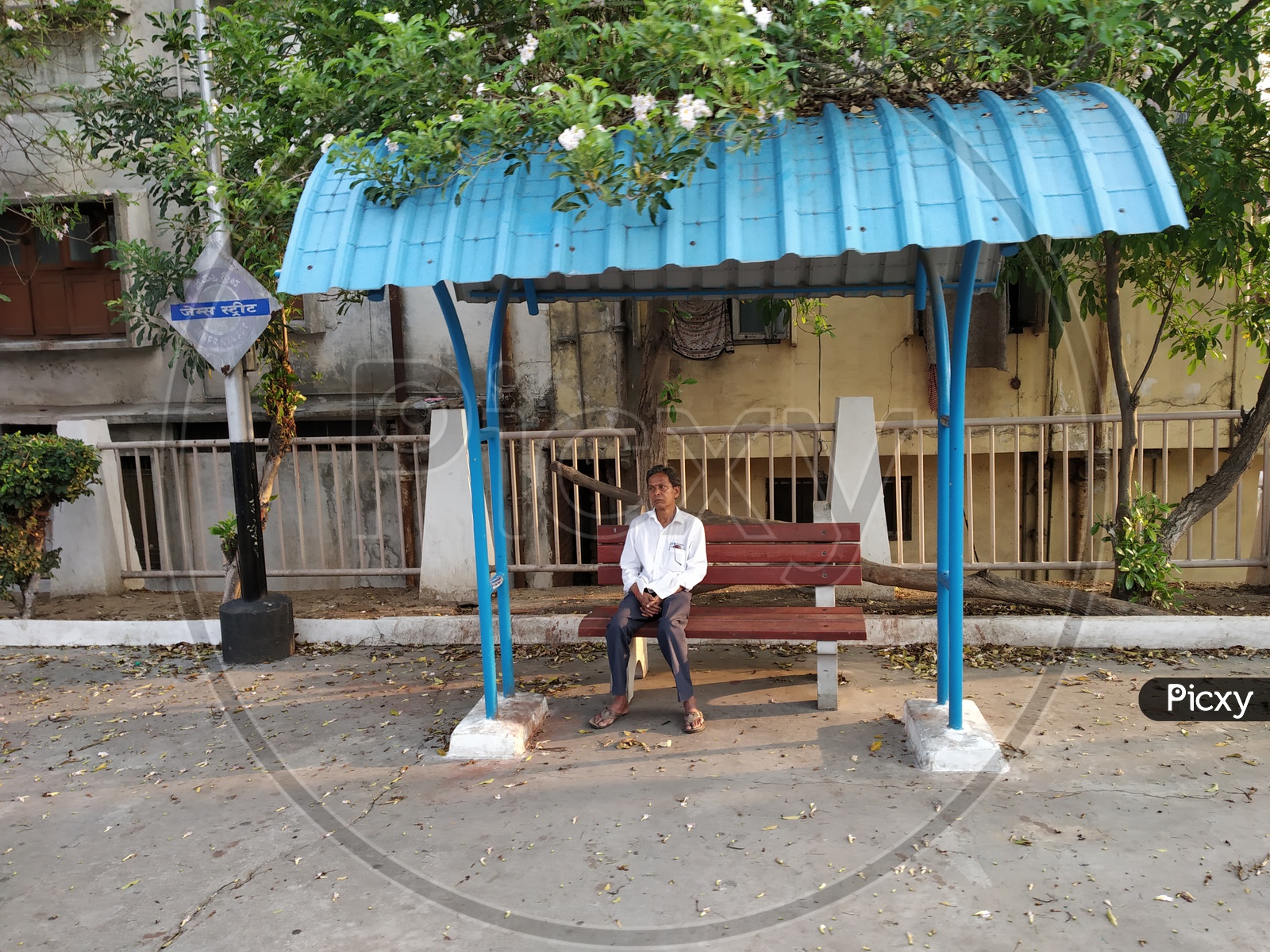A Man Sitting on the Bench on the Railway Platforms