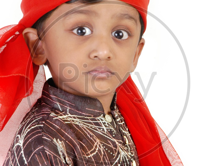 Indian boy wearing red head scarf