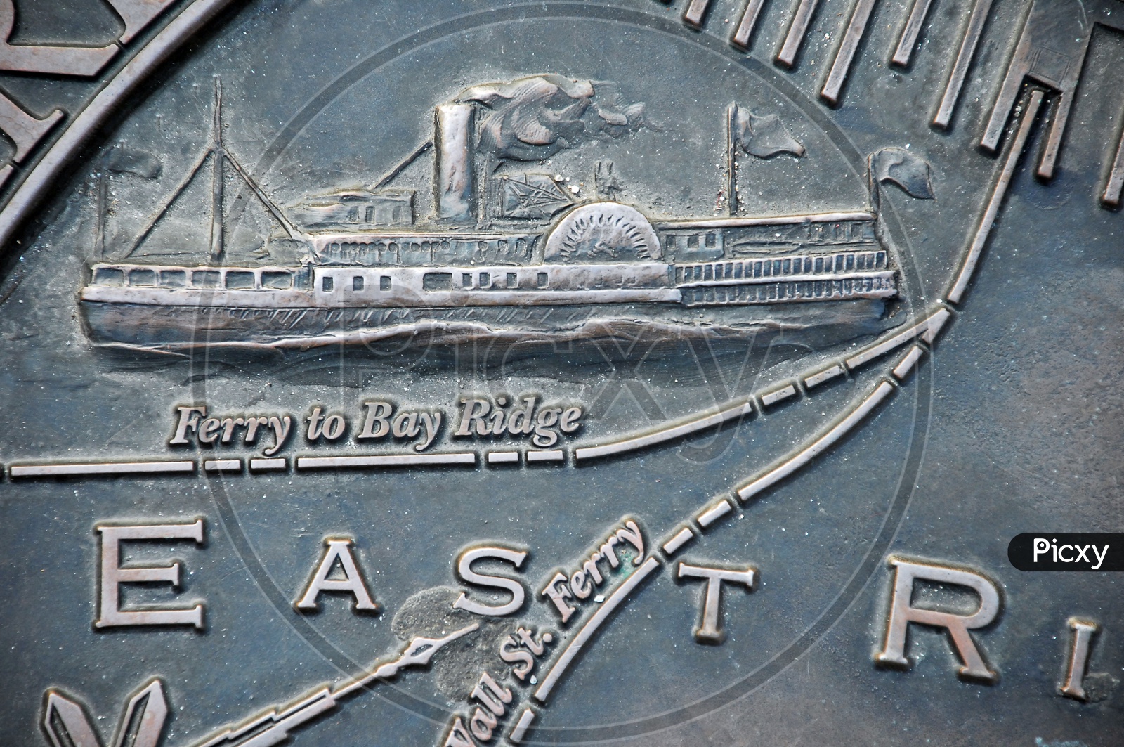 Illustration of a ferry embossed on a metal surface