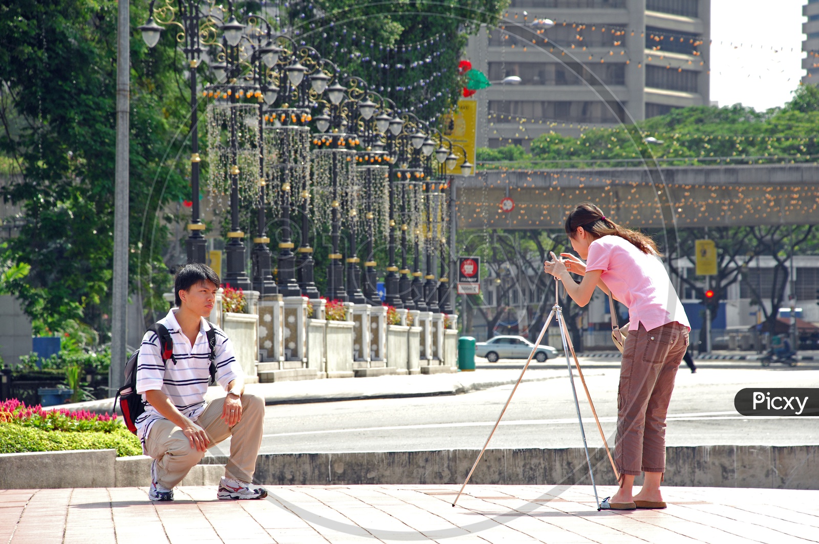 A Young Woman Taking Pictures With The Help of Tripod