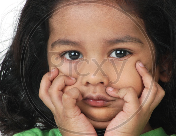 Indian little girl with her hands on the face