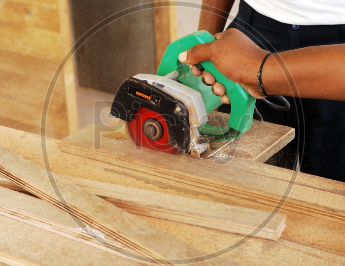 Carpenter Cutting Wood With Electronic Cutter