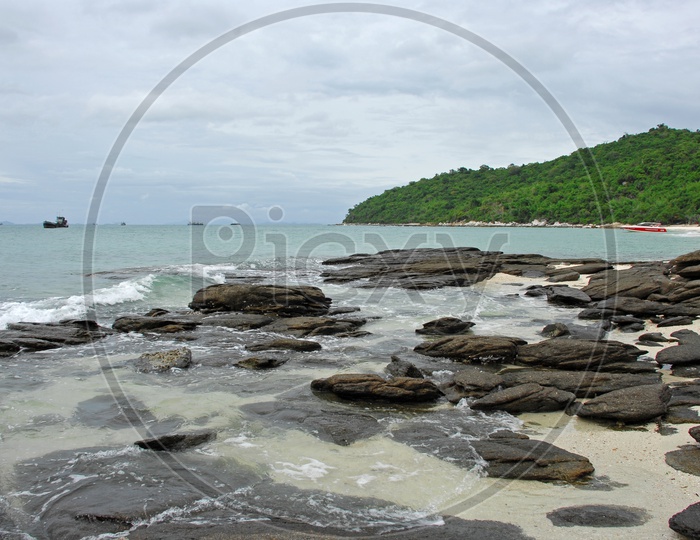 Rock beach With Waves  Striking To Rocks