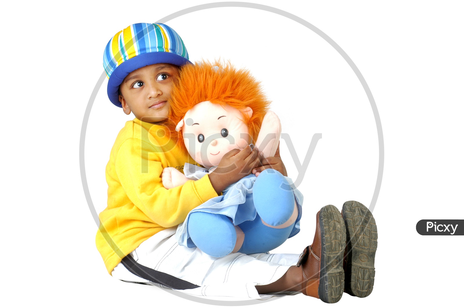 Indian boy wearing yellow t-shirt playing with toys
