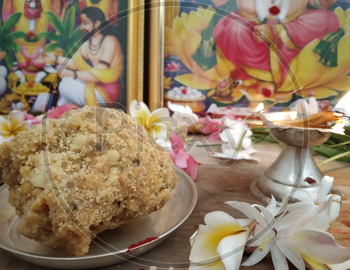 Tirrupathi Laddu Prasadam Being Offering to God Photo Frames  In Home