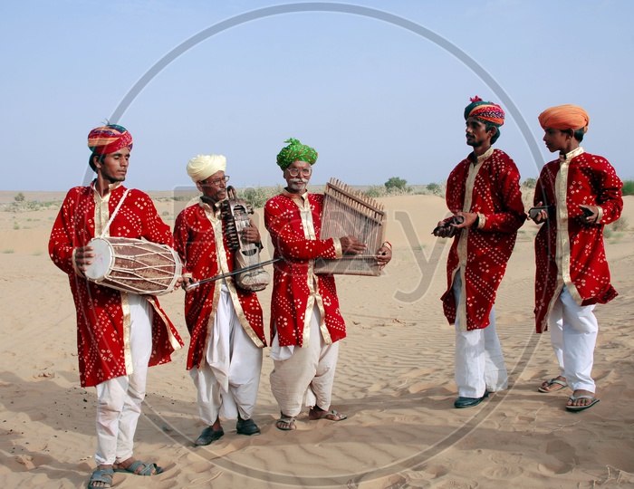 Rajasthani Men playing musical instruments in desert