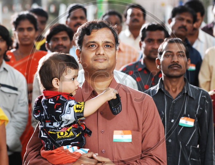 Indian man carrying his boy child