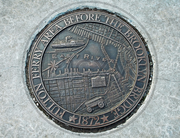 Representation of Fulton ferry area before the Brooklyn Bridge, 1872 on a metal