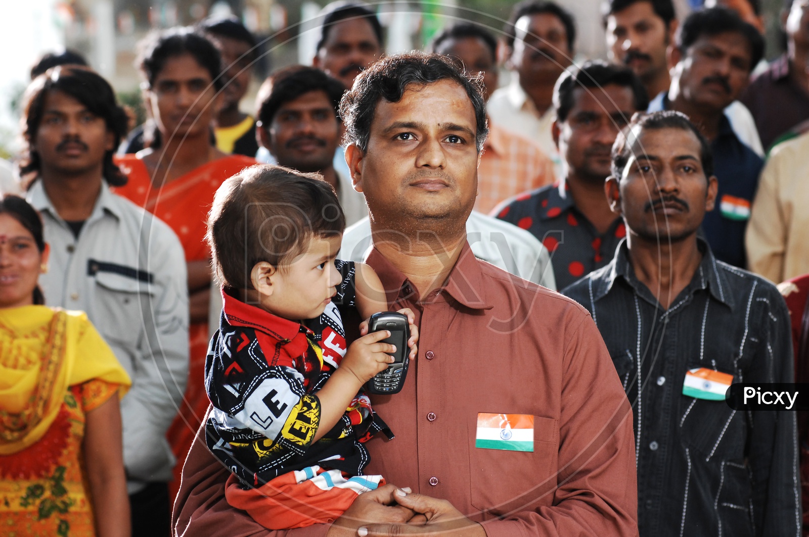 Father carrying his child during national anthem