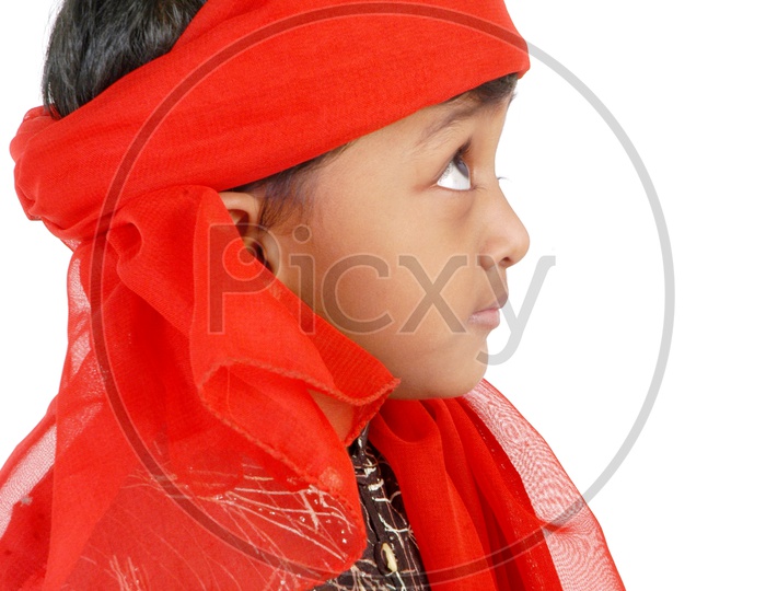 Indian boy wearing red head scarf