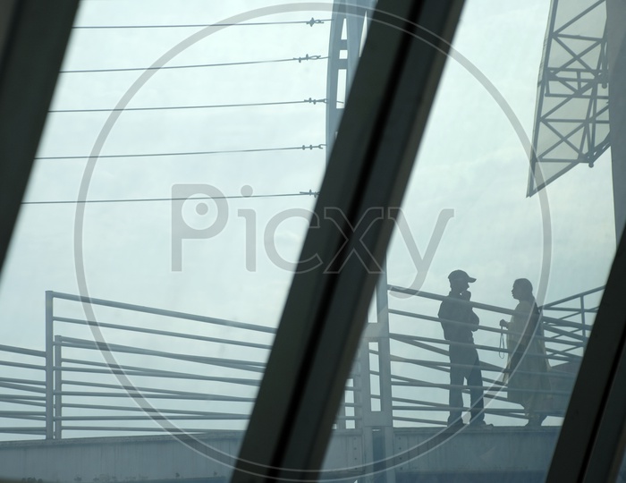 Silhouette of a Couple Talking In a Office Balcony