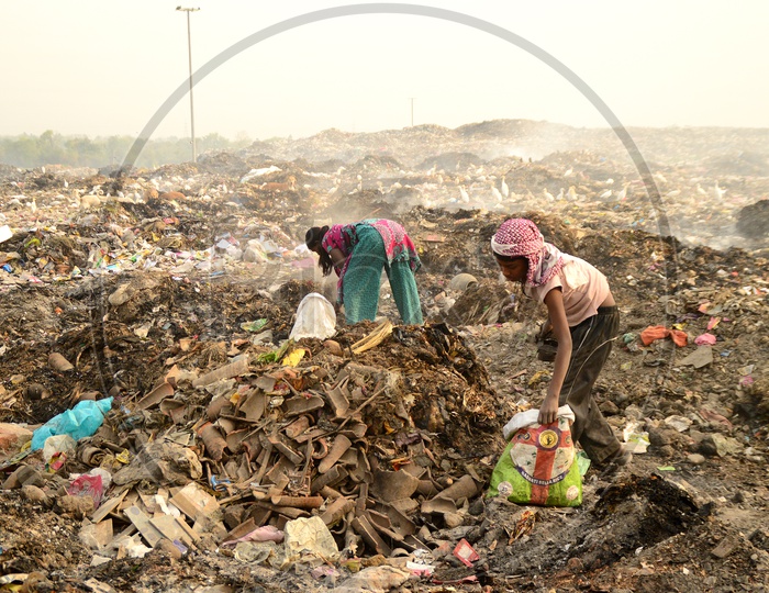 Unidentified Rag Pickers Collecting Recyclable Materials From Garbage Dumping Yard