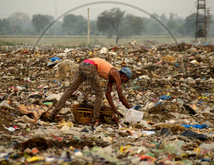 Unidentified Rag Pickers Collecting Recyclable Materials From Garbage Dump Yard