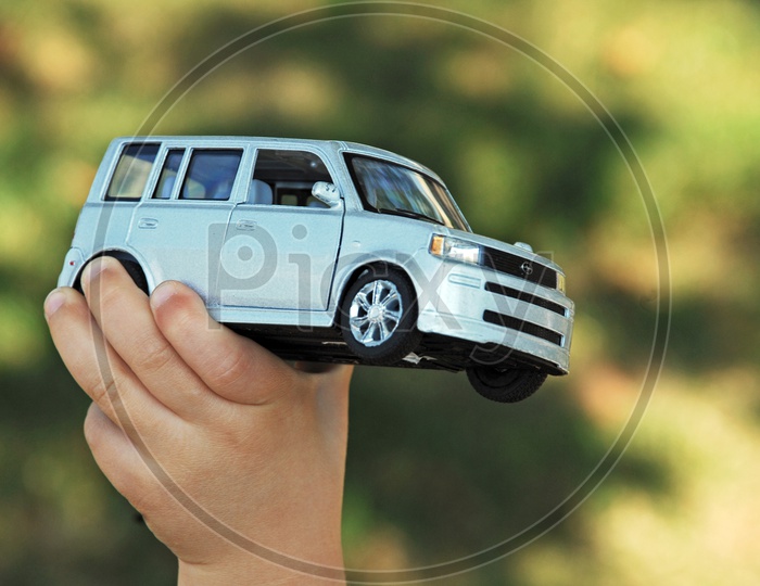 A Car Toy In a Child Hand