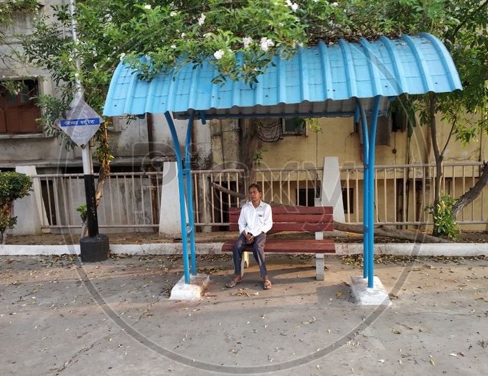 A Man Sitting on the Bench on the Railway Platforms