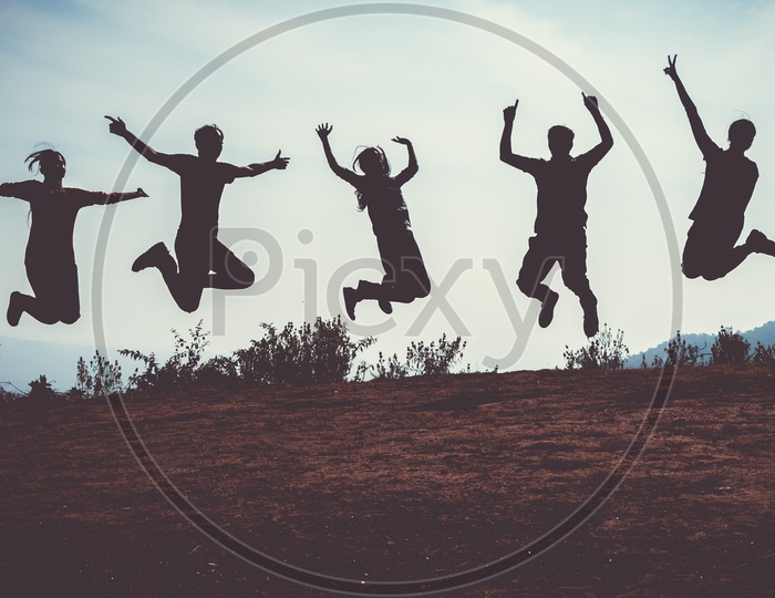 Friends jumping at once in air