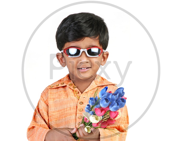 Indian boy wearing sunglasses holding flowers