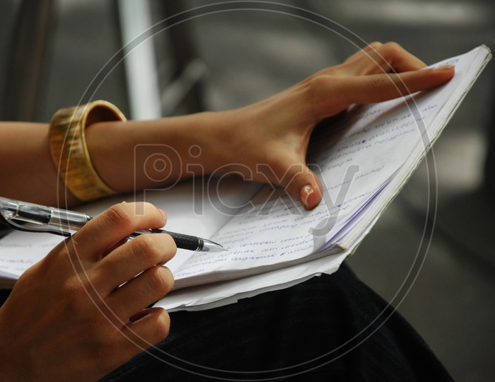 A girl writing with a pen