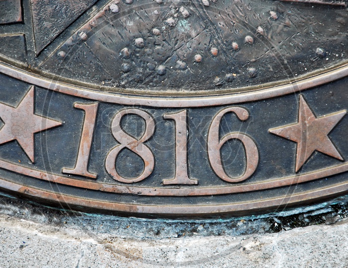 Number '1816' on a metal