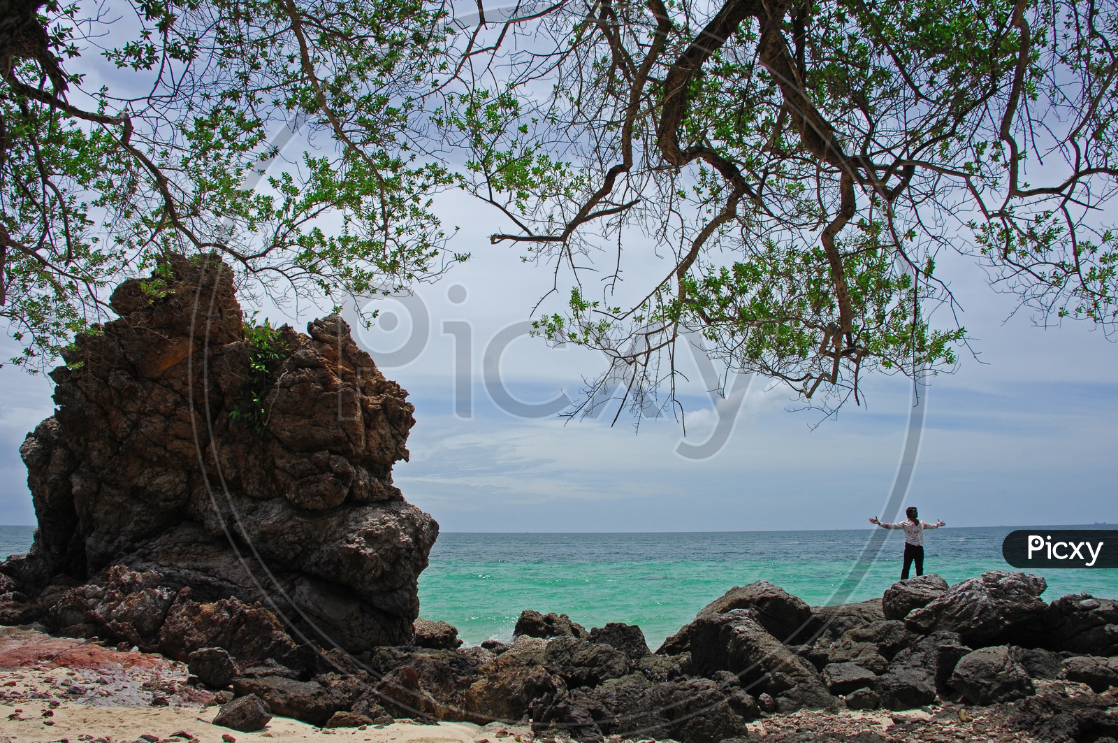 A Man Alone In a Rock beach