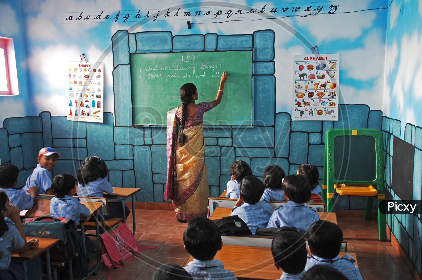A Lady Teacher Teaching In a Classroom At  a Kids School