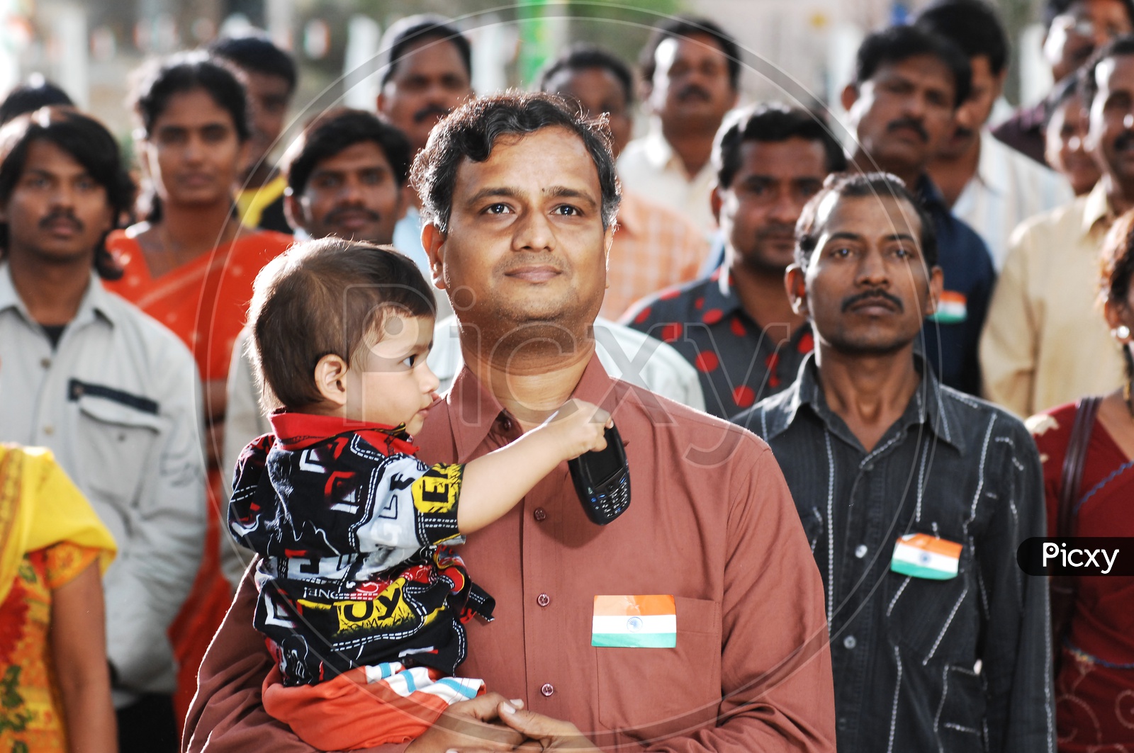 Indian man carrying his boy child
