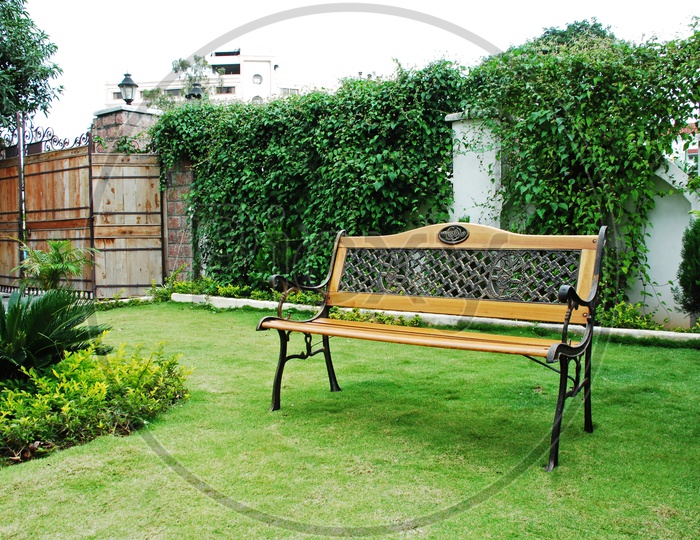 Wooden Bench In a House Lawn