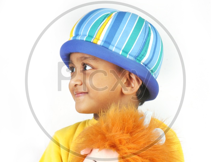 Indian boy wearing yellow t-shirt with toys