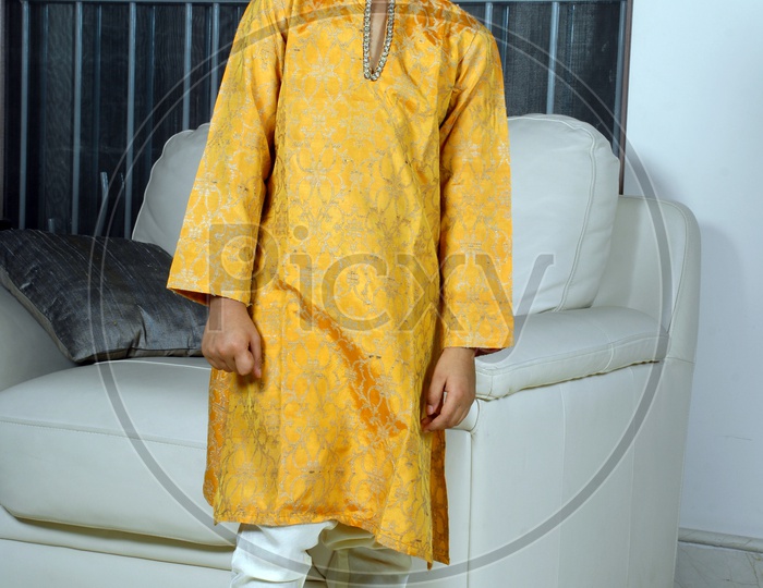 Indian boy wearing yellow kurta pyjama