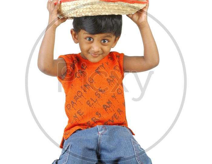 Indian boy wearing a sleeveless and a cowboy hat