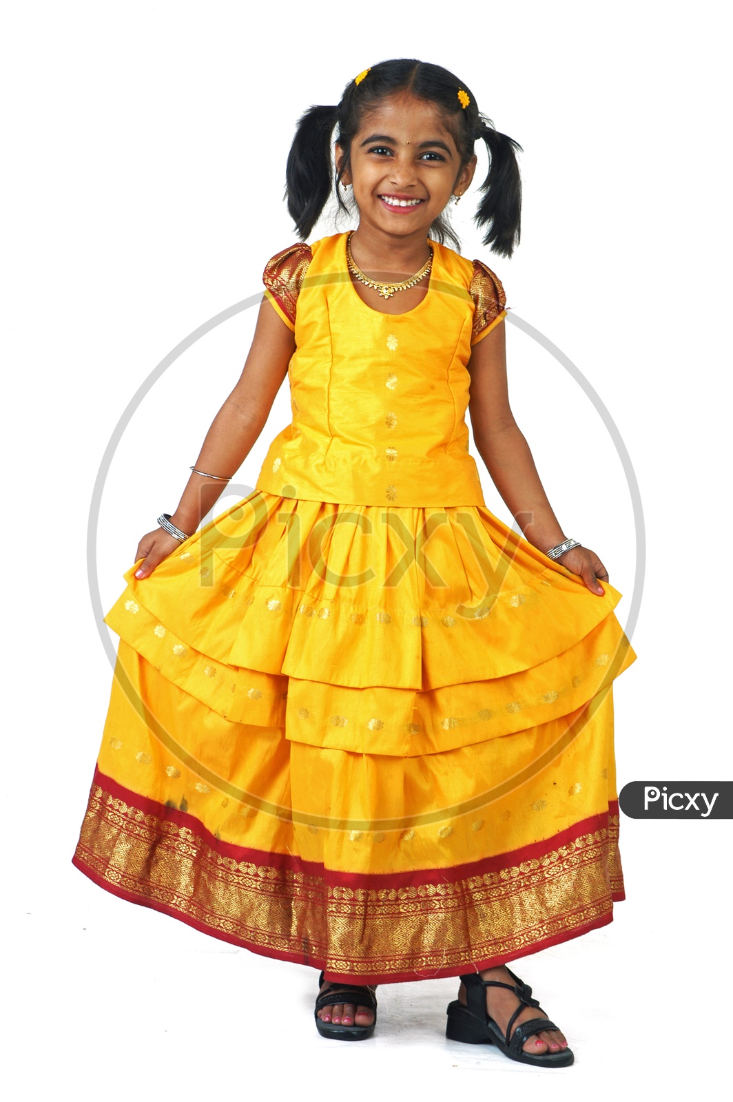 A little girl wearing traditional attire