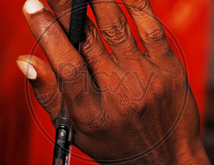 A  Man Holding a Pen In Hand