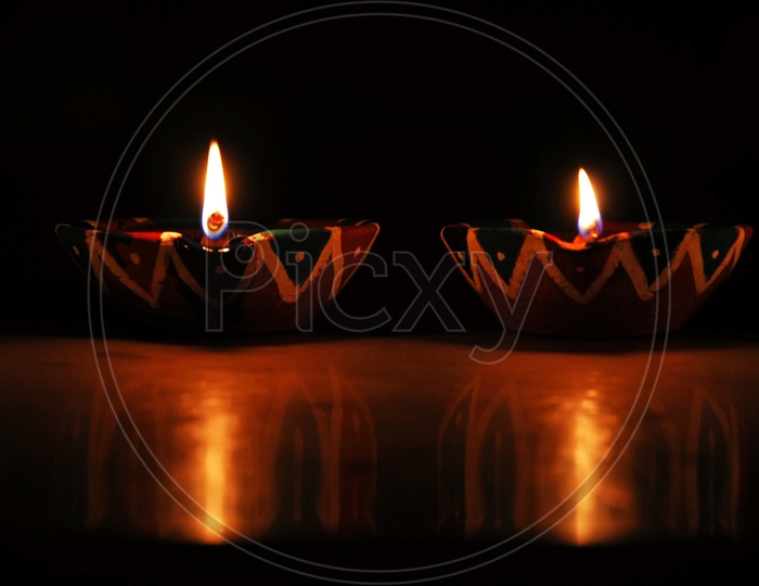 Diwali Dias Lighted In a Dark Room