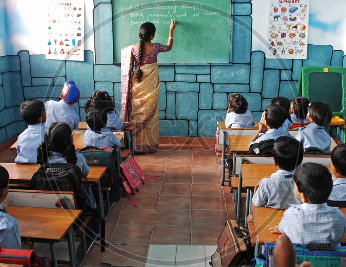 A Lady Teacher Teaching In a Classroom In a Kids School