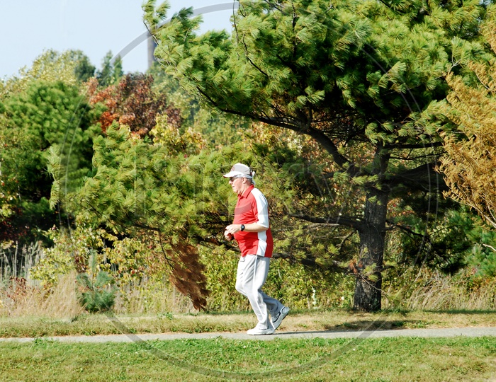 An old woman jogging in the park