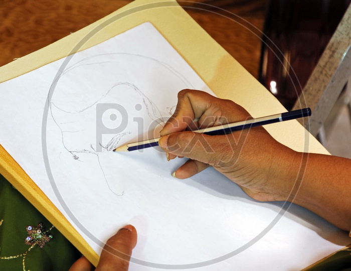 A woman artist drawing on paper