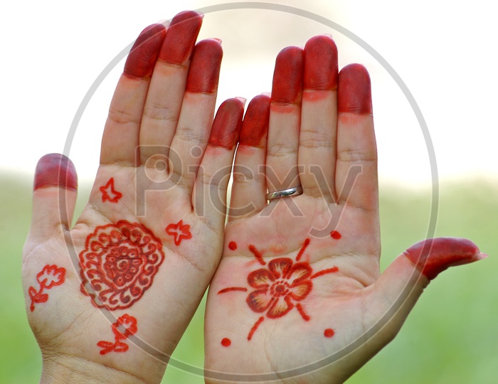 A Young Girl Hand With Color Design Or Mehandi