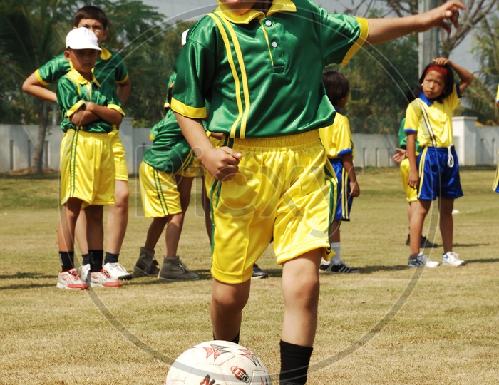 School kids playing football