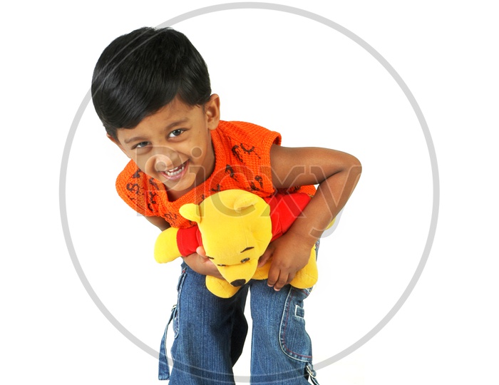 Indian boy holding a toy