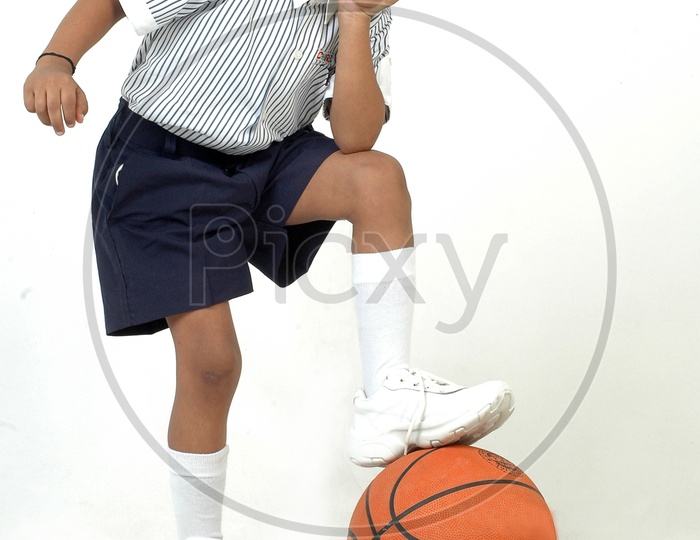 Indian boy wearing school uniform with basket ball