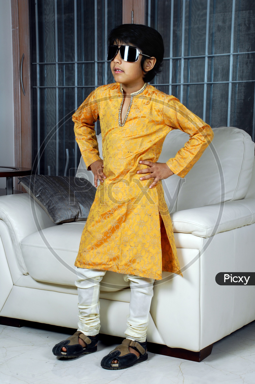 Indian boy wearing yellow kurta pyjama and sunglasses