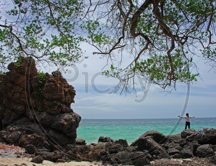 A Man Alone In a Rock beach