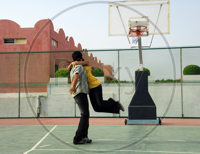 A man kissing the girl in the basketball court